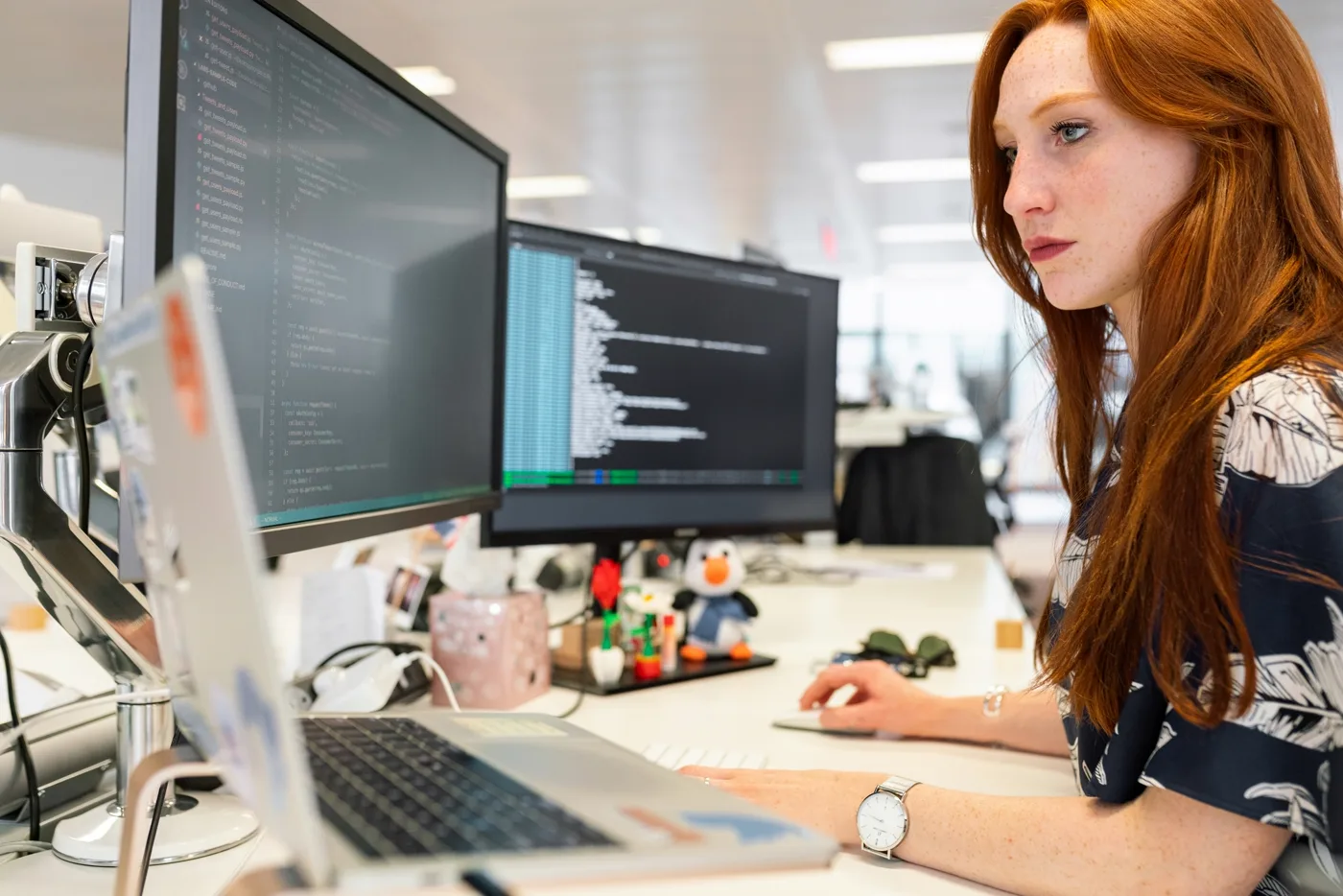 Developer working in a bright modern office building a mobile application