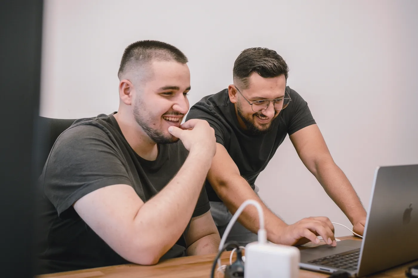Two designers collaborating over a tablet, reviewing a high-fidelity interface prototype